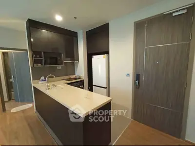 Modern kitchen with sleek cabinetry and open layout in contemporary apartment.