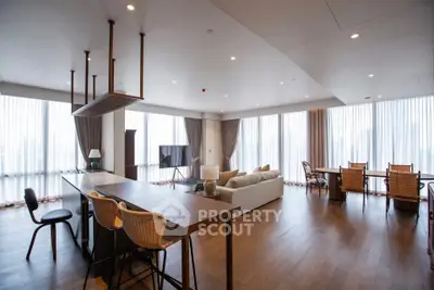 Spacious modern living room with open kitchen and large windows