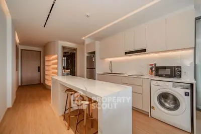 Modern kitchen with sleek white cabinetry and built-in appliances in a stylish apartment.