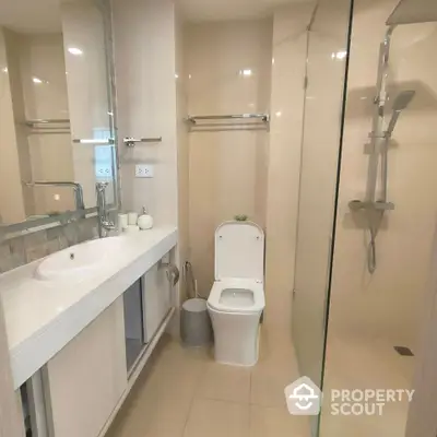 Modern bathroom with sleek fixtures and glass shower enclosure