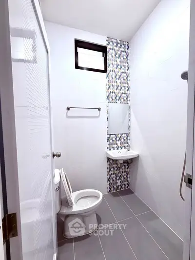 Modern bathroom with stylish tile accents and sleek fixtures, perfect for contemporary living.