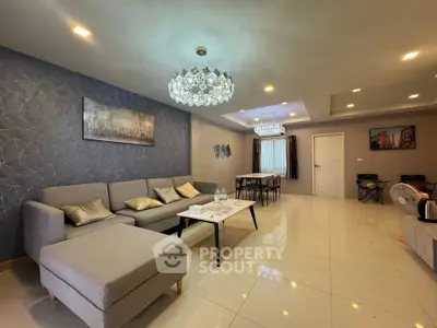 Spacious modern living room with elegant chandelier and stylish decor