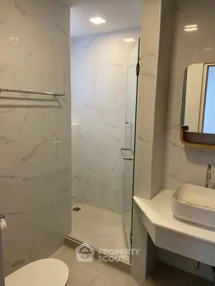 Modern bathroom with glass shower and sleek fixtures