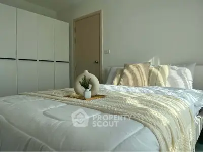 Cozy bedroom with modern decor and ample natural light