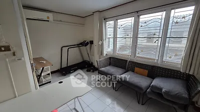 Cozy living room with treadmill and large windows for natural light