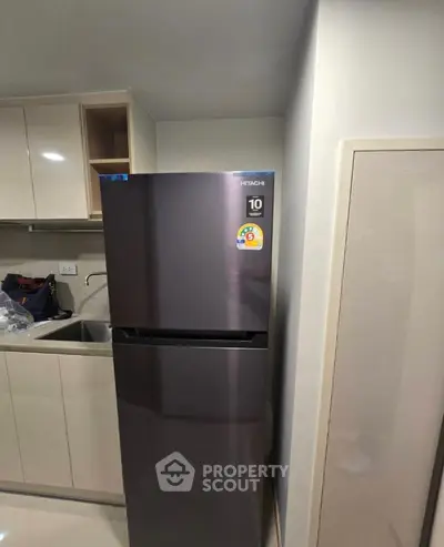Modern kitchen with sleek fridge and stylish cabinetry