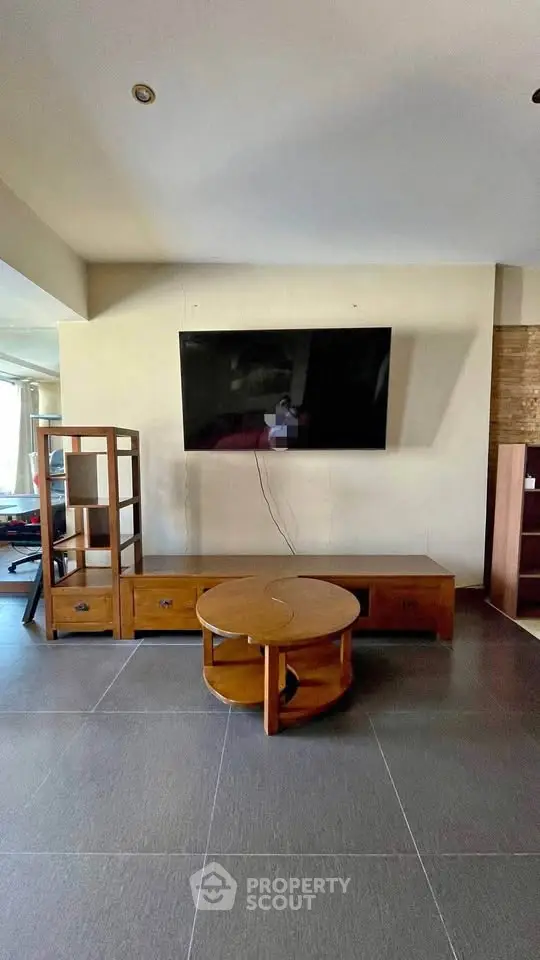 Modern living room with sleek TV setup and stylish wooden furniture