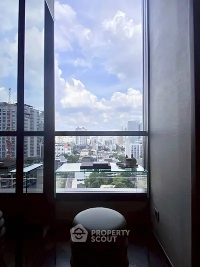 Stunning city view from a modern high-rise balcony with glass railing.