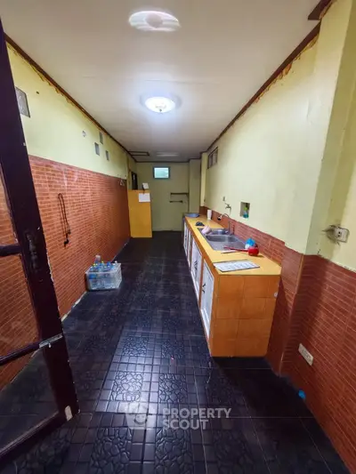 Spacious kitchen with closed layout and tiled flooring