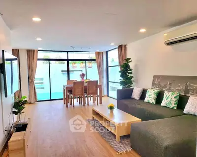 Spacious modern living room with large windows and stylish decor