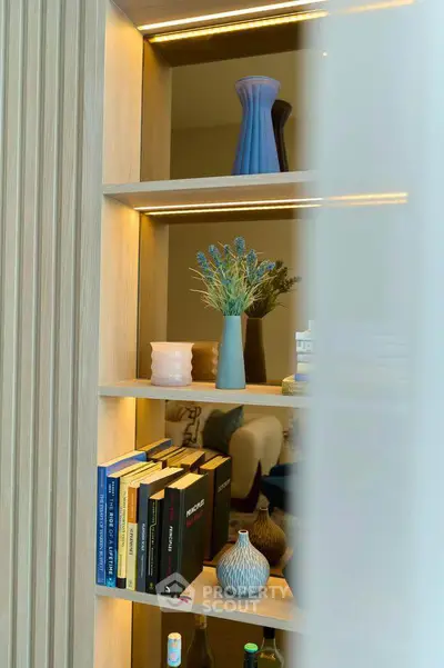 Stylish interior shelving with decorative vases and books in a modern living space.