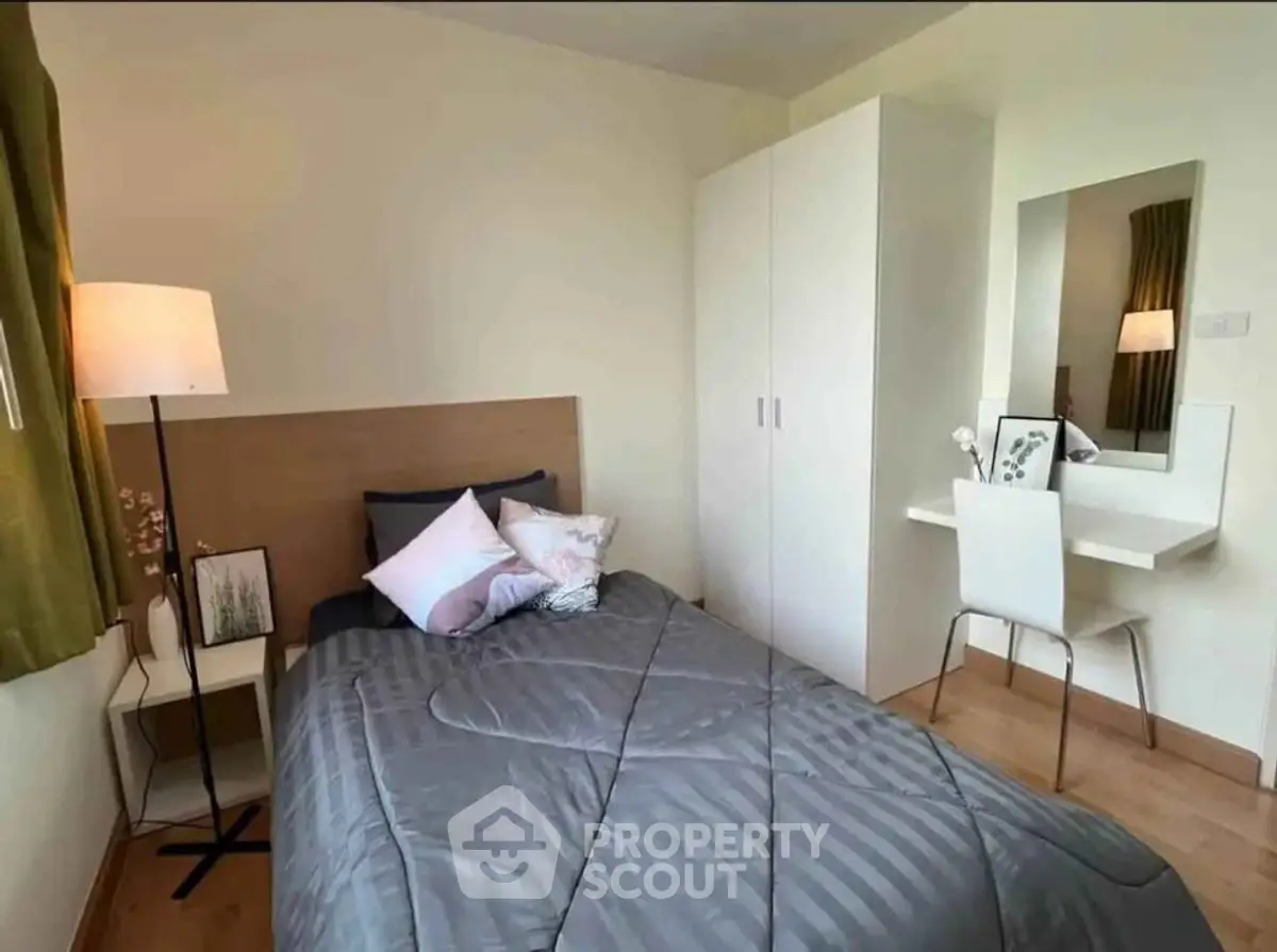 Cozy bedroom with modern decor, featuring a comfortable bed, stylish wardrobe, and elegant vanity area.