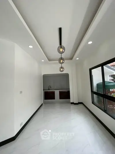 Modern interior with sleek lighting and large window, perfect for a stylish living space.