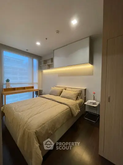 Modern bedroom with cozy lighting and stylish decor in a contemporary apartment.