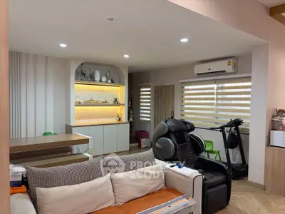 Modern living room with massage chair and treadmill, featuring stylish decor and cozy ambiance.