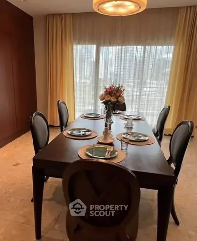 Elegant dining room with stylish table setting and large windows offering natural light.