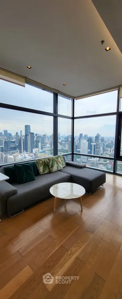 Luxurious living room with panoramic city view and modern furnishings.
