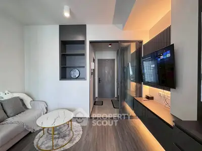 Modern living room with sleek design, cozy sofa, and wall-mounted TV, perfect for relaxation.