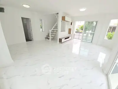 Spacious modern living room with marble flooring and natural light