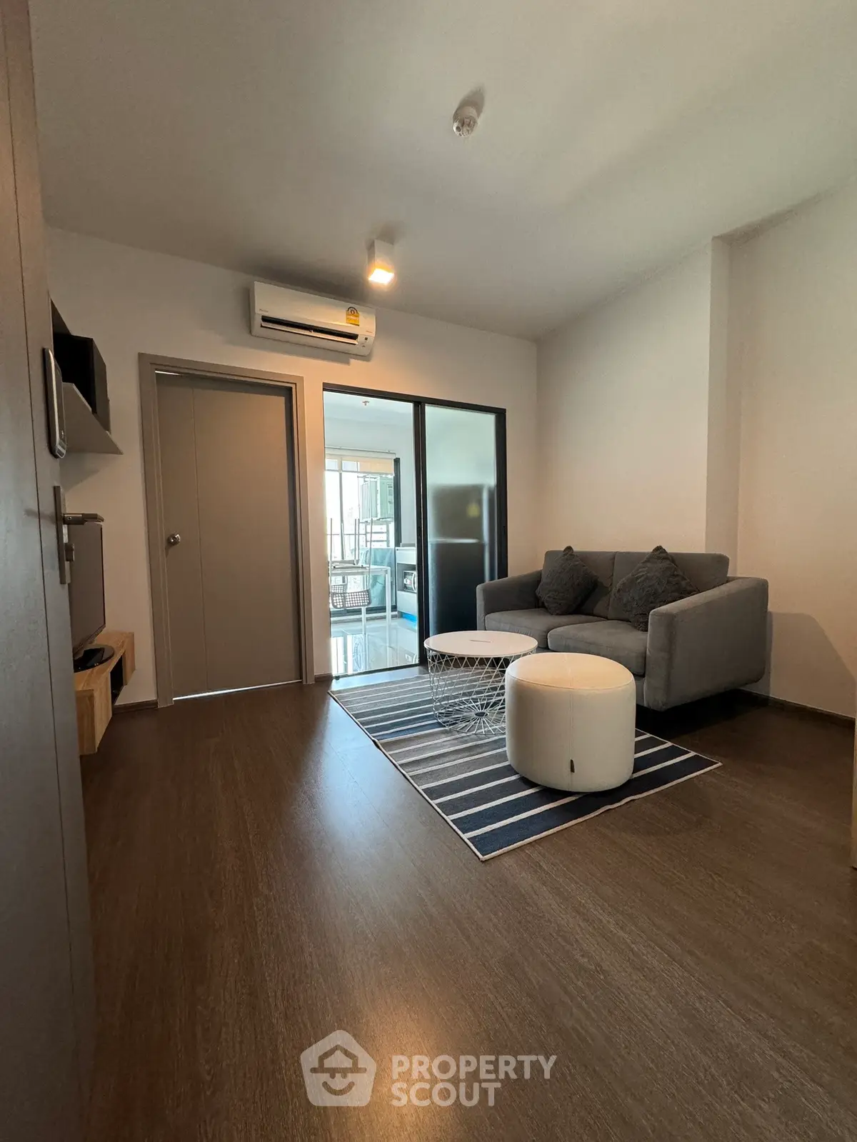 Modern living room with cozy sofa and stylish decor in a contemporary apartment.