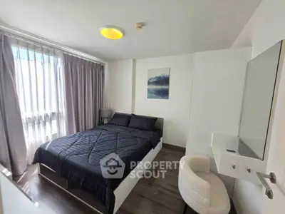 Modern bedroom with stylish decor and natural light in a contemporary apartment.