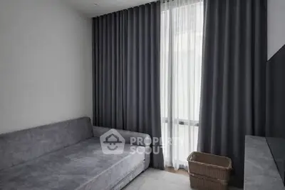 Cozy minimalist living room with gray sofa and floor-to-ceiling curtains