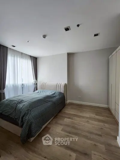 Modern bedroom with stylish decor and natural light