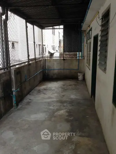 Spacious outdoor balcony area with industrial design and metal fencing.