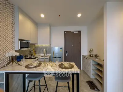 Modern kitchen with marble countertop and stylish decor in a contemporary apartment.