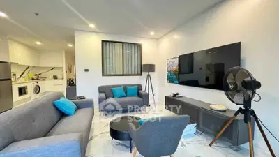 Modern living room with stylish furniture and open kitchen layout