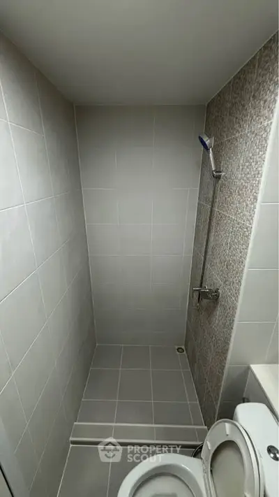 Modern minimalist bathroom with sleek shower design and neutral tiles.
