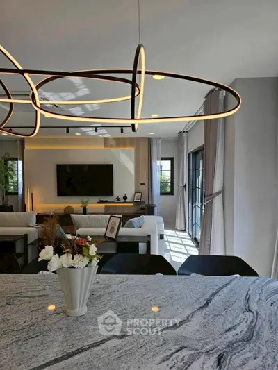 Luxurious modern living room with elegant lighting and spacious open layout, perfect for stylish living.