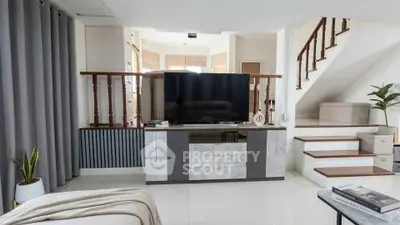 Modern living room with sleek TV stand and stylish staircase