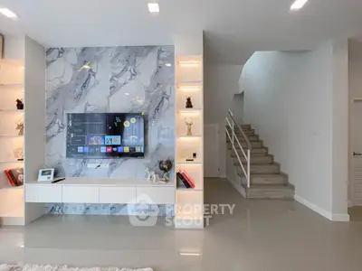 Modern living room with stylish marble TV wall and sleek staircase