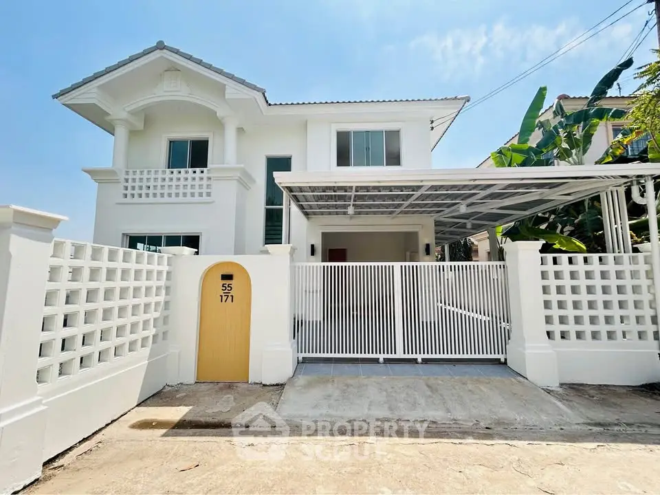 Charming two-story white house with gated entrance and carport in a sunny neighborhood.