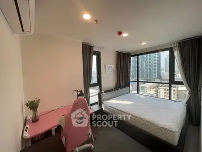 Modern bedroom with city view, featuring stylish furniture and large windows for natural light.