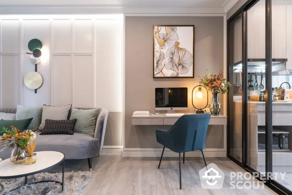 Elegant living room seamlessly connects to a modern kitchen, featuring stylish furnishings, chic decor, and a warm, inviting ambiance perfect for entertaining or relaxation.