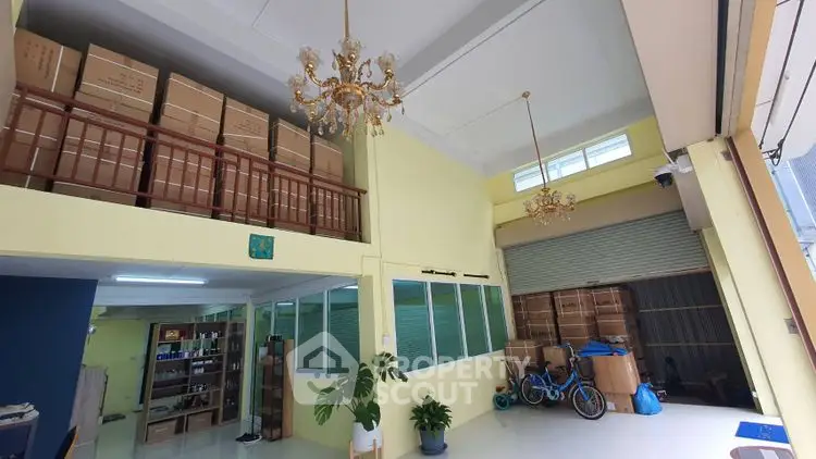 Spacious storage area with high ceilings and elegant chandeliers