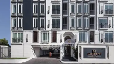 Elegant modern building facade with stylish windows and entrance at Maestro 01 Residence.