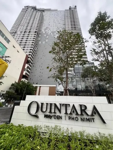 Modern high-rise building with sleek design and lush landscaping at Quintara Pho Nimit.