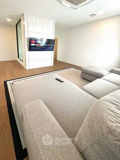 Spacious modern living room with sleek design and large sectional sofa.