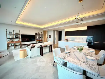 Luxurious open-plan living and dining area with modern kitchen and elegant decor