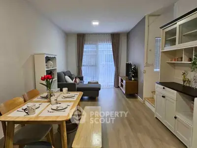 Charming living room with cozy dining area and elegant decor, perfect for modern living.