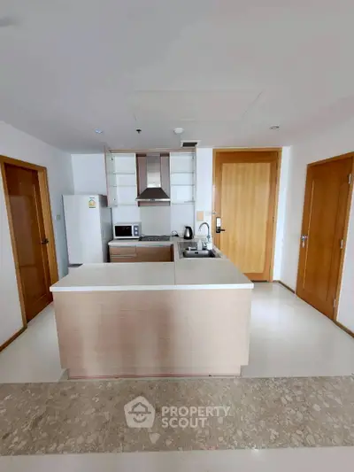 Modern kitchen with sleek design and open layout, featuring stainless steel appliances and ample storage space.