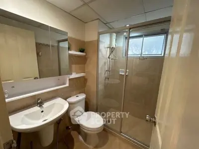 Modern bathroom with glass shower and sleek fixtures