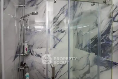 Modern bathroom with sleek marble shower and glass doors