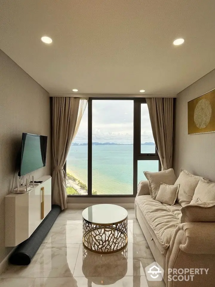 Luxurious living room with stunning ocean view, elegant decor, and modern furnishings.