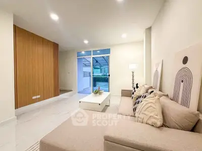Modern living room with stylish decor and large windows for natural light.