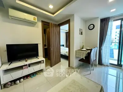 Modern apartment interior with TV, dining area, and balcony view