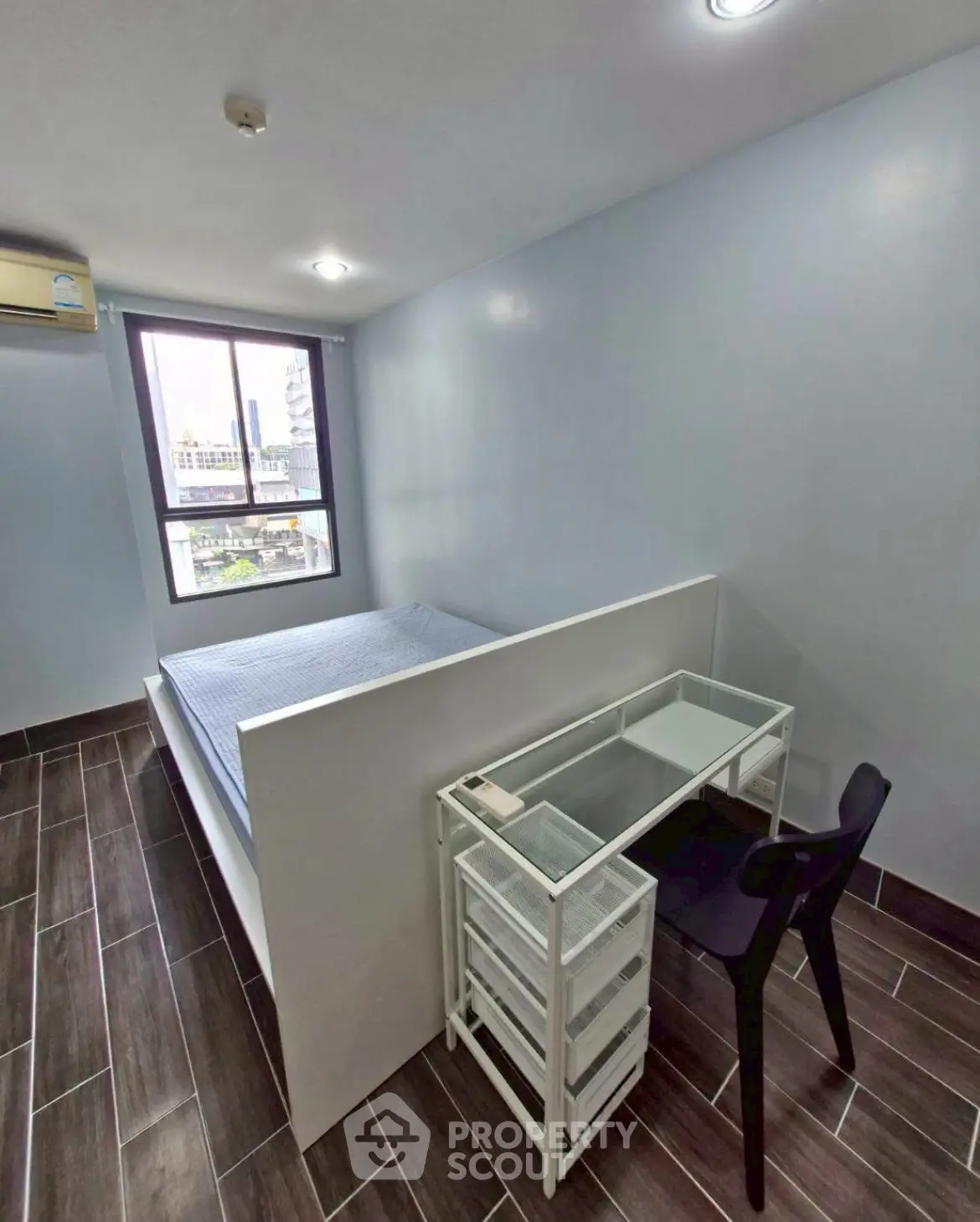 Modern minimalist bedroom with sleek design and city view window, perfect for urban living.